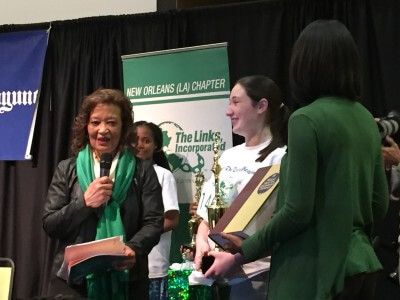 Alaina McDuffie, center, receiving her trophy from The Links at the local New Orleans spelling bee. McDuffie will compete in the national competition on May 22. 