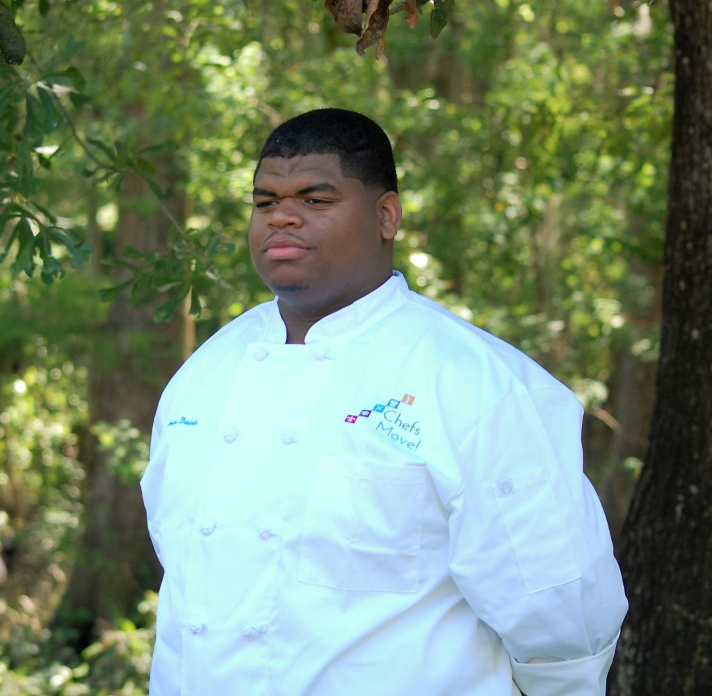 Delvin Davis receiving his Chefs Move! scholarship at Chef John Besh's home. (Courtesy photo)